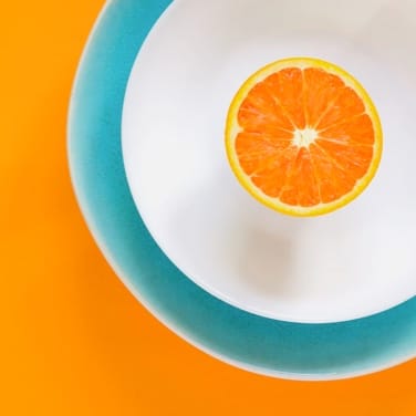 a half of orange in a bowl